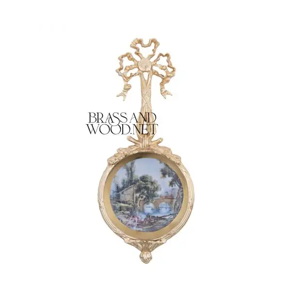 Round wall frame in golden brass with ornate ribbon top classic decorative design featuring scenic artwork for luxury home decor